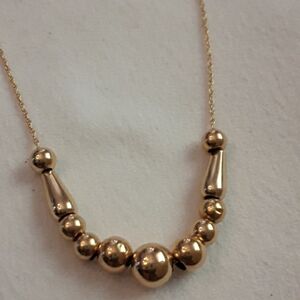 14k gold add a bead  necklace with nine 14k round beads and two 10k sphere bead